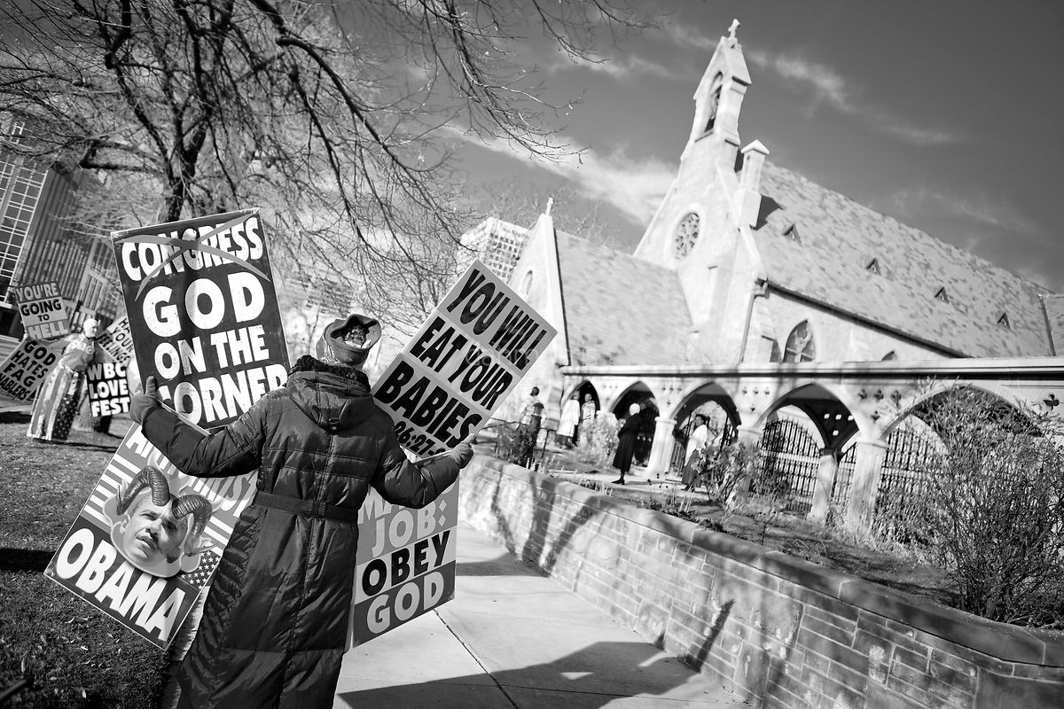 Rachel Hockenbarger, protesting in front of St. Mark's Episcopal Church in Salt Lake City.  She is a member of the Westboro Baptist Church and daughter of Pastor Fred Phelps. She works on legal/logistical details for WBC.  The Westboro Baptist Church has become notorious in the United States for picketing the funerals of fallen US soldiers.  Their claim is that god is punishing America for allowing gay rights. (Dan Morris)