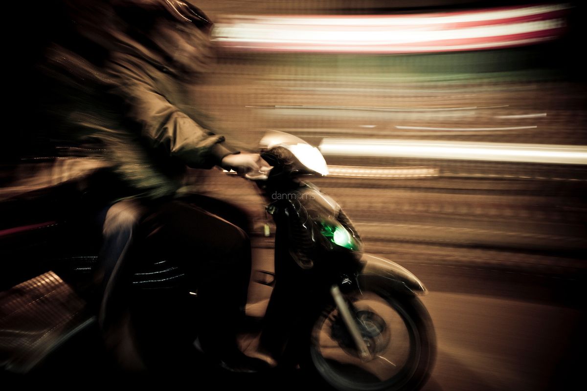 Tron Driving scooter at night, French Quarter, Hanoi, Vietnam (Dan Morris Photography)